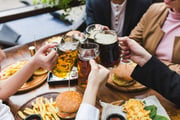 friends-toasting-with-beer-restaurant-min